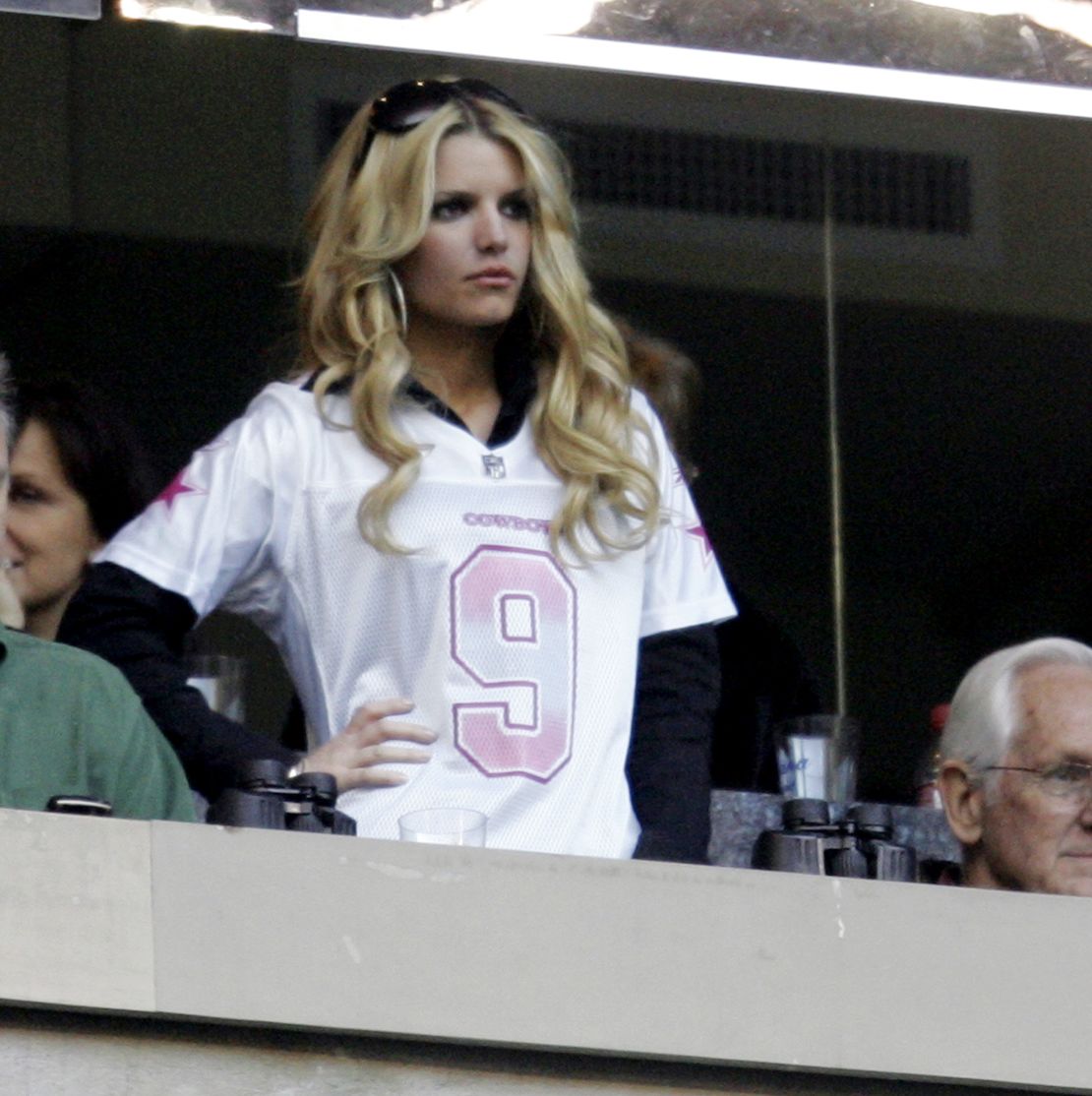 Jessica Simpson wears Dallas Cowboys quarterback Tony Romo's jersey during the 2007 Eagles-Cowboys football game in Texas.